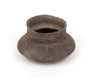 Ancient pottery vessel with incised decoration, unknown age and origin, 6cm high, 10cm wide.