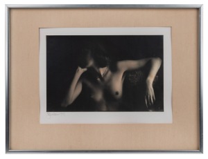 Black and white photograph of a female nude, signed lower left (illegible), sheet size 16 x 24.5cm, 32 x 42cm overall.