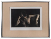 Black and white photograph of a female nude, signed lower left (illegible), sheet size 16 x 24.5cm, 32 x 42cm overall.