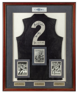 CARLTON limited edition No.2 guernsey, signed by GREG WILLIAMS, JOHN NICHOLS, and PETER MOTLEY, attractively framed and glazed with black and white action photographs of each player. ​​​​​​​109 x 89cm overall.