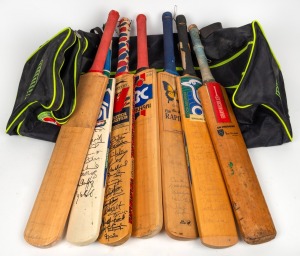 A collection of seven full-sized cricket bats, one match-used and the others signed by various teams; mixed condition, housed in a Puma international cricket carry bag. (7 items)