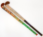 A Vijayanti hockey stick with applied fabric, signed by the 1998 Indian hockey team, who were competing in Australia, together with another hockey stick with many signatures illegible.