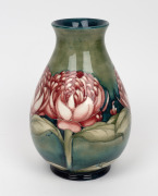 MOORCROFT "Waratah" baluster shaped English pottery vase on blue and green ground, impressed signature cartouche "W. Moorcroft, Potter to H. M. The Queen. Made in England" with underglazed blue signature mark "W. Moorcroft", 25cm high - 2
