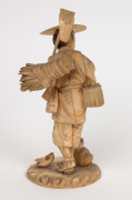 An antique Japanese carved ivory okimono statue of a farmer, Meiji Period, 19th/20th century, seal mark to base, 24cm high - 2