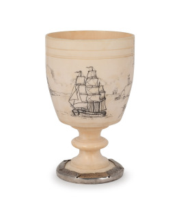 An antique ivory goblet, attractively adorned with engraved scrimshaw coastal scene with tallships and castles, 19th century, later silver restoration to foot, 13cm high.