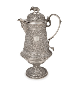 A fine quality Indian Kutch silver water jug with elephant finial and face mask spout, most likely the work of the famed silversmith OOMERSI MAWJI (1860-1930), 26cm high, 810 grams.