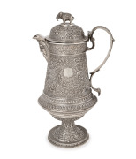 A fine quality Indian Kutch silver water jug with elephant finial and face mask spout, most likely the work of the famed silversmith OOMERSI MAWJI (1860-1930), 26cm high, 810 grams.
