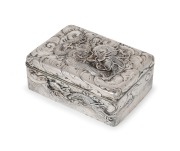 An antique Japanese export silver box decorated with dragons and clouds, Meiji Period, 19th century, 6cm high, 15.5cm wide, 11cm deep, 524 grams.
