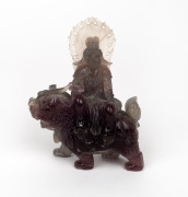 A Chinese carved hardstone figure riding on a mythical creature, 19th/20th century, ​​​​​​​16cm high.