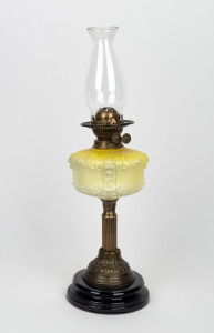 Antique oil lamp with embossed yellow glass font, duplex double button burner, screw mount, brass column and black base, 19th century, 56cm high overall.
