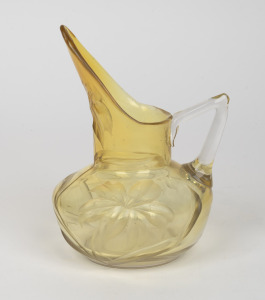 An antique hand-blown unusual glass jug with lemon vaseline blush, handsomely decorated with deep intaglio floral motif, 19th century, 17cm high.