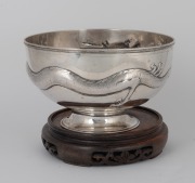 TUCK CHANG & Co. of Shanghai Chinese export silver dragon bowl on later wooden stand by noted silversmith GAN SHENG of Hong Kong, 19th/20th century, 11.5cm high (not including base), 19.5cm diameter, 573 grams. Gan Sheng (active circa 1895-1930) operated - 2