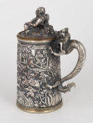 An antique Chinese silver plated export ware tankard and cover, handsomely decorated with dragon handle, seated Buddha and battle scene, engraved "RAGLAN ARCHERS, Aug. 26. 1868", ​​​​​​​17cm high. - 2