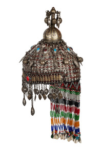 A vintage tribal Turkoman silver wedding headdress, adorned with beadwork and glass, 20th century, 50cm high overall.