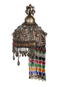 A vintage tribal Turkoman silver wedding headdress, adorned with beadwork and glass, 20th century, 50cm high overall.