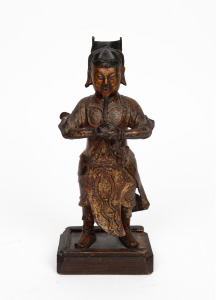 An antique Chinese cast bronze figure of a warrior with remains of gilt finish, mounted on later wooden base, 18th/19th century, 29cm high.