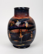 MOORCROFT English pottery vase decorated with trees in landscape and rare flambe glaze, underglazed blue signature mark "W. Moorcroft, 1941" with impressed signature mark and original paper label "By Appointment, Potter to H. M. The Queen", 28cm high. - 2
