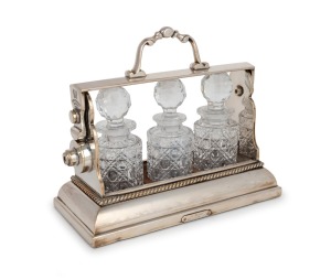 An antique English silver plated three bottle tantalus of diminutive size, stamped "THE TANTALUS, BETJEMANS PATENT, LONDON", 19th century, 20cm high, 23cm wide.