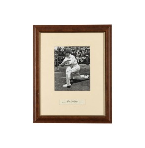 DON BRADMAN: An original press photograph, showing Bradman practicing in the nets, attractively signed in pen, c. 1948, framed and glazed, 51 x 41cm overall.