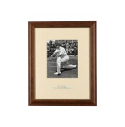 DON BRADMAN: An original press photograph, showing Bradman practicing in the nets, attractively signed in pen, c. 1948, framed and glazed, 51 x 41cm overall.