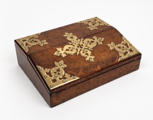 An antique English burr walnut ladies lap desk, attractively adorned with brass hardware in the Gothic style, interior fitted with original blue velvet writing surface and brass topped inkwells, mid 19th century, 10cm high, 30cm wide, 23cm deep.