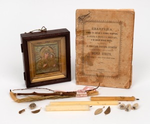 A Russian travelling icon of the Virgin Mother and Child, gilt metal with hand-painted features in timber case, early 20th century, accompanied with a 1918 publication in Cyrillic, 12 x 11cm overall.