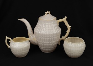 BELLEEK Irish porcelain three piece tea service with shell motif, 20th century, green factory mark to base, the teapot 19cm high.