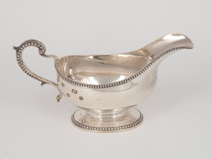 A vintage English sterling silver sauce boat, made in London, 20th century, 9.5cm high, 19.5cm long, 272 grams.