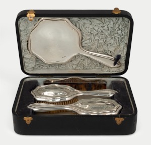 A vintage sterling silver boxed four piece vanity dressing set, retailed by Walker & Hall, early 20th century, the box 32cm wide.