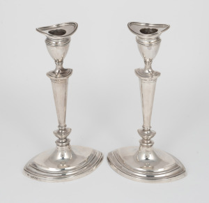 A pair of antique sterling silver candlesticks with weighted bases, made in London, early 20th century, ​​​​​​​20cm high, 625 grams total (including weighted bases).
