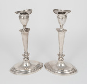 A pair of antique sterling silver candlesticks with weighted bases, made in London, early 20th century, ​​​​​​​20cm high, 625 grams total (including weighted bases).