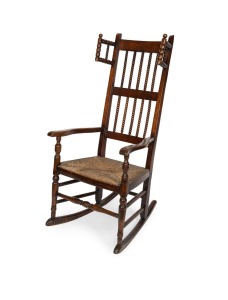 An antique Lancashire rocking nursing chair, elm and fruitwood with rush seat, circa 1800, 115cm high, 56cm across the arms