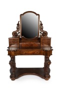 An antique huon pine dressing table with carved decoration, circa 1875. Note: Later walnut stain. A good restoration project. 175cm high, 123cm wide, 63cm deep
