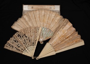 Three antique carved ivory fans with lace and silk adornments, 19th century, the largest 38cm high, 66cm wide.