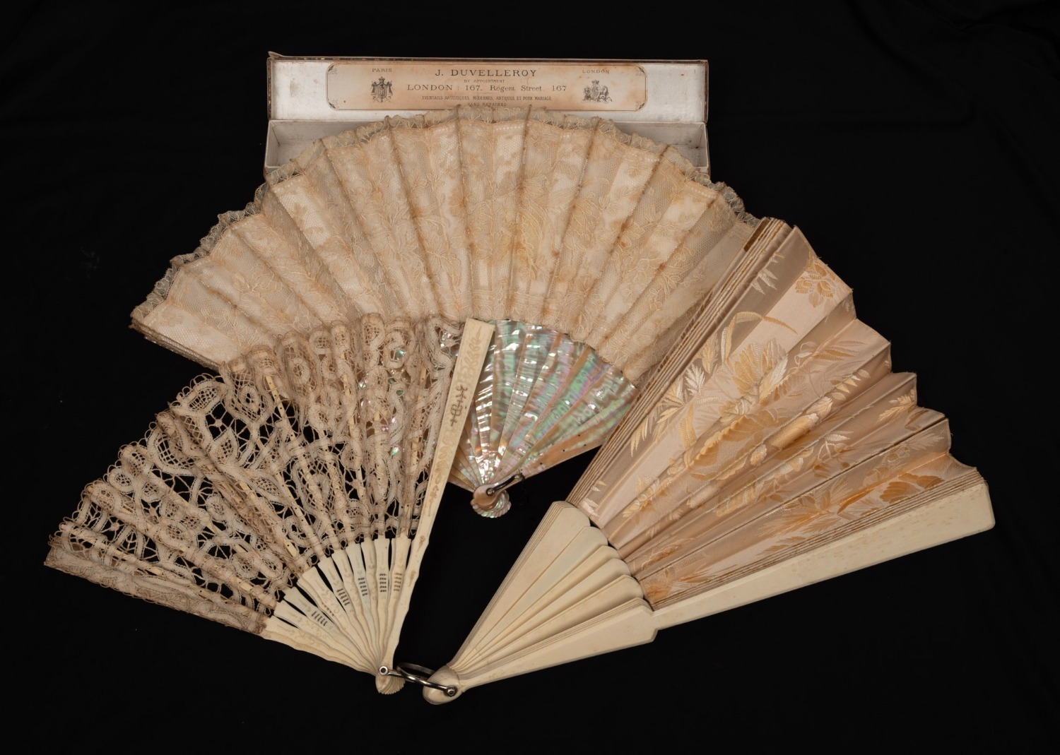 Ivory Fan Three antique carved ivory fans with lace and silk adornments, 19th ...