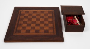 Antique carved bone chess pieces in timber box; together with an Australian cedar, blackwood and kauri pine chess board, 19th century. Note: Missing one red pawn, otherwise complete and with four additional pieces. The kings 8cm high, base 3.3cm diameter.