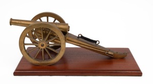 A miniature model cannon, mounted on Australian cedar base, early to mid 20th century, barrel 20cm long, 43cm overall.