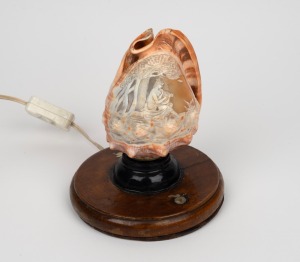 An Italian carved cameo shell converted to a lamp, 19th/20th century, ​​​​​​​18cm high overall.