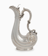 An antique sterling silver Rococo Revival shell form claret jug by Walker & Hall, Chester, circa 1906, 33cm high, 980 grams.