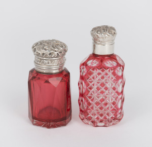 Two antique silver topped ruby glass scent bottles, 19th century, 7cm and 8.5cm high.