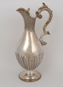 An antique silver plated wine ewer with shell decoration, 19th century, 33cm high.