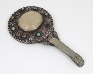 A Chinese silver and carved mutton jade hand mirror adorned with cabochon semi-precious stones and housed in a later silk box, 24cm high.