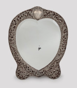 An antique English sterling silver framed heart shaped table mirror, made for Thomas Webb of Melbourne, Birmingham, circa 1902, 42 x 33cm.