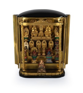 An antique Japanese black lacquered travelling shrine, interior sumptuously fitted and decorated with polychrome and gilt statues, Meiji Period, 19th/20th century, 78cm high, 58cm wide, 42cm deep.