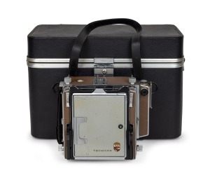 LINHOF: Super Technika IV field camera [#68125] with Schneider-Kreuznach Symmar-S 100mm f5.6 lens [#13451302], additional Schneider-Kreuznach Symmar 150mm f5.6 lens [#4133617], additional camera back, plus focusing hood and leather case, c. 1973.