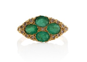 An 18ct gold ring, set with four impressive cut emeralds surrounded by diamonds, 20th century, 4.8 grams