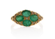 An 18ct gold ring, set with four impressive cut emeralds surrounded by diamonds, 20th century, 4.8 grams