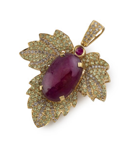 An 18ct yellow gold pendant, set with an impressive cabochon natural ruby, surrounded by alternating rows of brilliant cut diamonds and peridots, 5.5cm high overall, 15.4 grams.