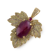 An 18ct yellow gold pendant, set with an impressive cabochon natural ruby, surrounded by alternating rows of brilliant cut diamonds and peridots, 5.5cm high overall, 15.4 grams.