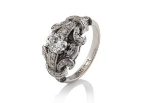 An Art Deco 18ct white gold and platinum ring set with brilliant cut white diamonds, stamped "18ct PLAT", 4.5 grams total.
